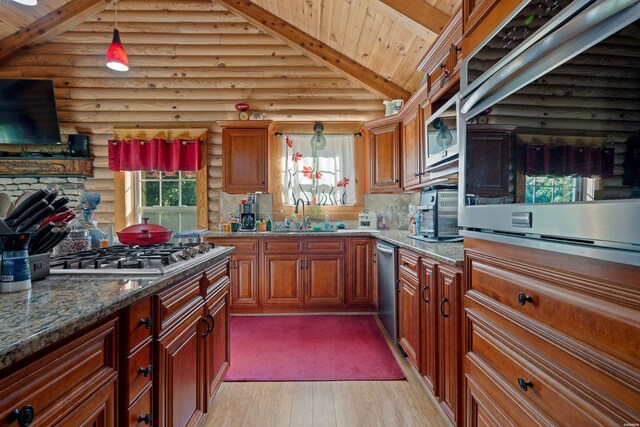 kitchen with wooden ceiling, appliances with stainless steel finishes, dark stone countertops, decorative light fixtures, and vaulted ceiling with beams