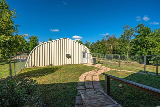 view of yard with fence and an outdoor structure