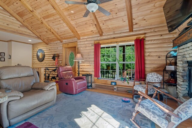 living room featuring wooden ceiling, wood finished floors, a fireplace, high vaulted ceiling, and beam ceiling