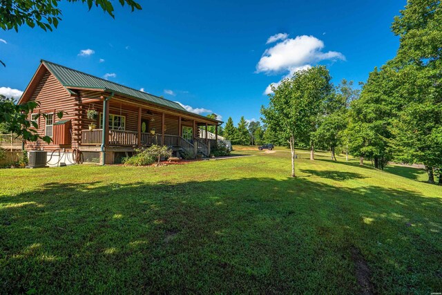 view of yard with central AC and a wooden deck