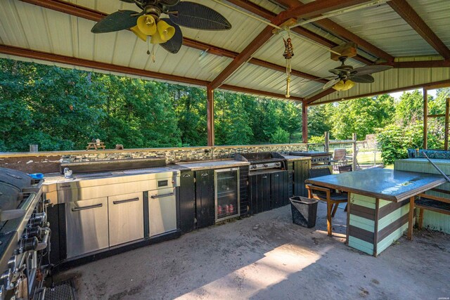 view of patio with grilling area, a gazebo, a ceiling fan, exterior kitchen, and beverage cooler