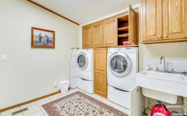 133 Treasure Isle Rd, Hot Springs, AR 71913 - clothes washing area with washing machine and clothes dryer, a sink, ornamental molding, cabinet space, and light tile patterned floors