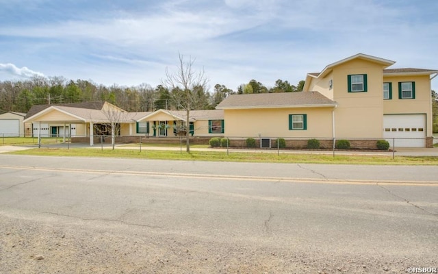 133 Treasure Isle Rd, Hot Springs, AR 71913 - traditional-style home featuring stucco siding, driveway, fence private yard, a detached carport, and a garage