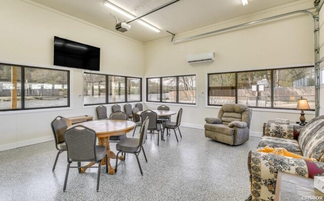 133 Treasure Isle Rd, Hot Springs, AR 71913 - dining area featuring a wall mounted air conditioner, a wealth of natural light, speckled floor, and baseboards