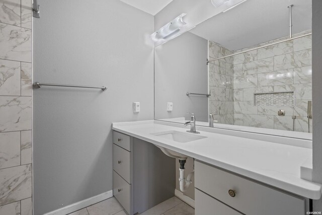 bathroom featuring baseboards and a sink