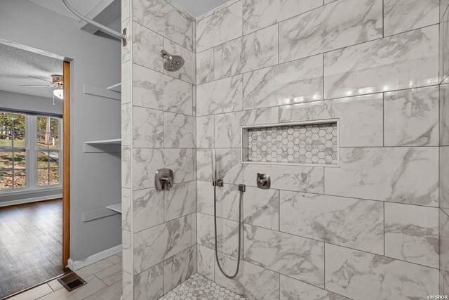 full bath featuring visible vents, ceiling fan, a textured ceiling, and walk in shower