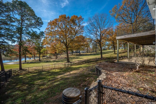 view of yard with a water view and fence