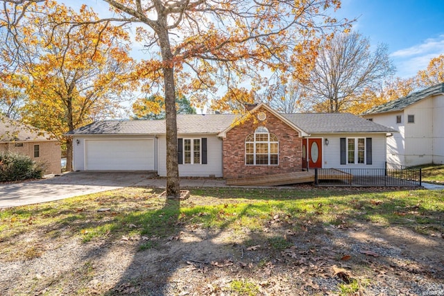 single story home with a garage, concrete driveway, and brick siding