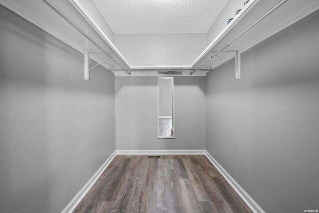 walk in closet featuring wood finished floors and visible vents