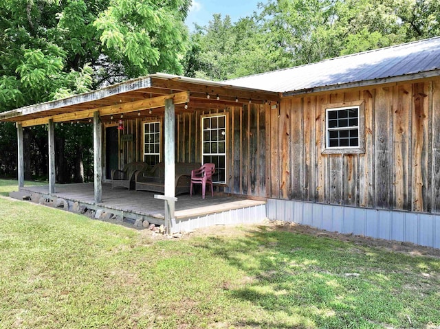 21 Chris Rd, Amity, AR 71921 - back of house featuring a yard, a wooden deck, and metal roof
