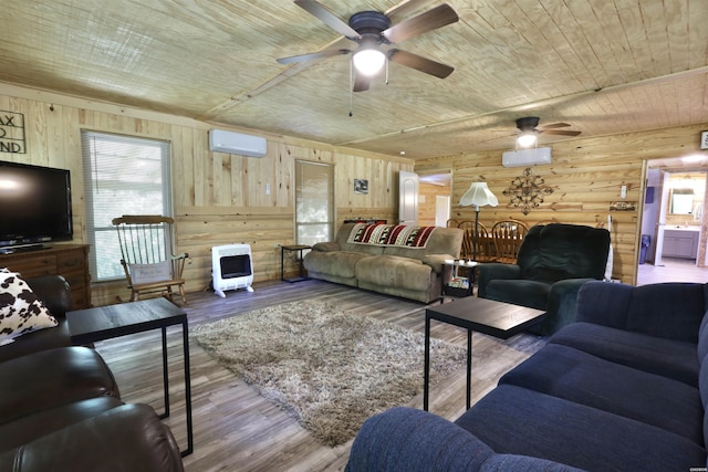 21 Chris Rd, Amity, AR 71921 - living room featuring a wall unit AC, wood ceiling, a ceiling fan, heating unit, and wood walls