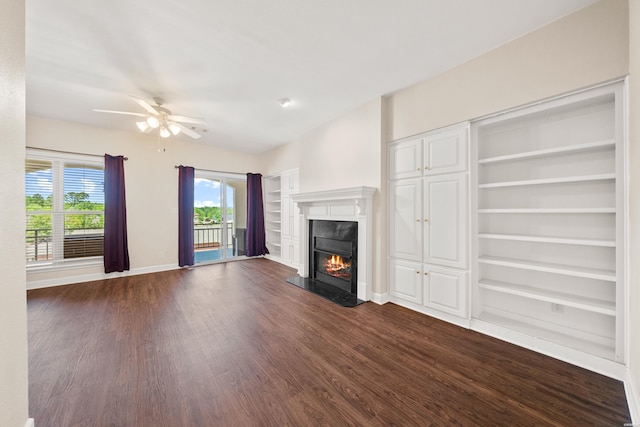 518 Amity Rd Unit E4, Hot Springs, AR 71913 - unfurnished living room with baseboards, built in shelves, a premium fireplace, ceiling fan, and dark wood-type flooring