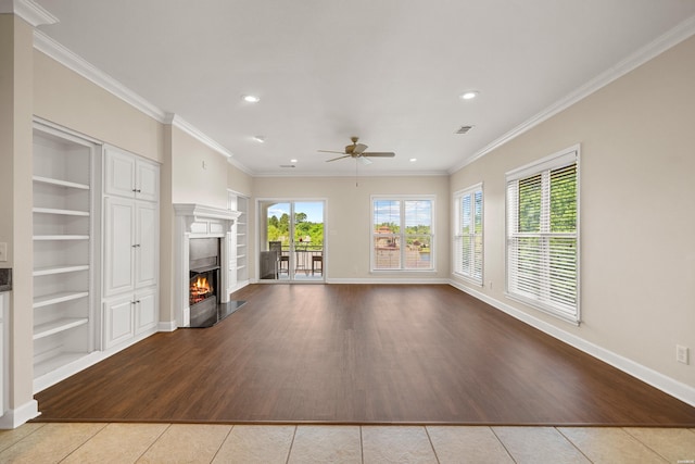 518 Amity Rd Unit E4, Hot Springs, AR 71913 - unfurnished living room featuring tile patterned flooring, a warm lit fireplace, a ceiling fan, baseboards, and built in shelves