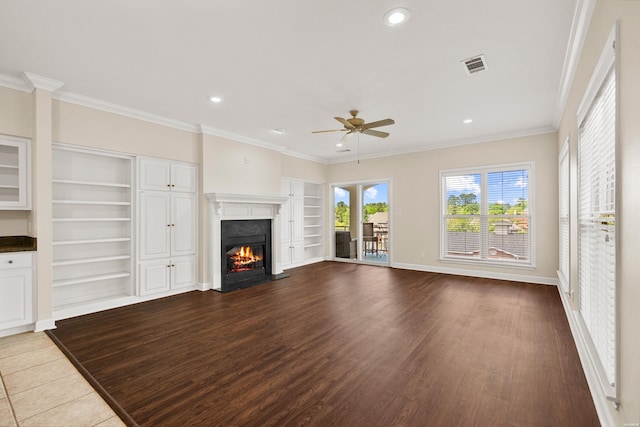 518 Amity Rd Unit E4, Hot Springs, AR 71913 - unfurnished living room featuring ceiling fan, a warm lit fireplace, visible vents, built in features, and dark wood-style flooring