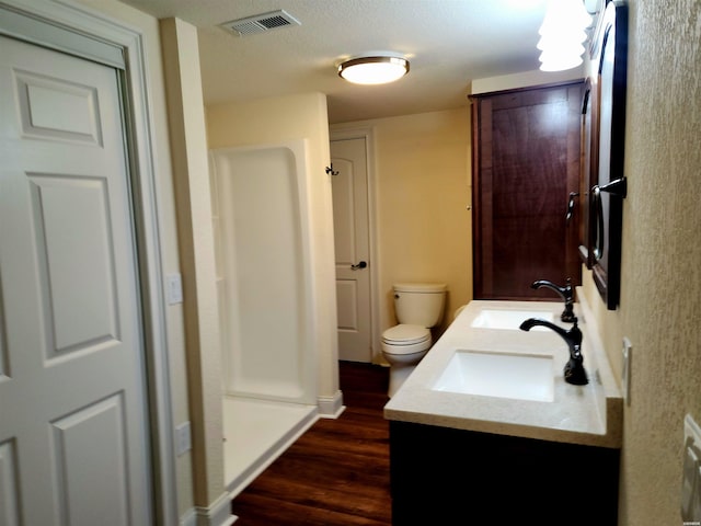 full bathroom featuring a sink, visible vents, toilet, and wood finished floors