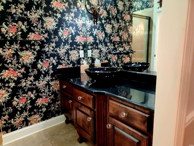 bathroom featuring tile patterned floors, vanity, and baseboards