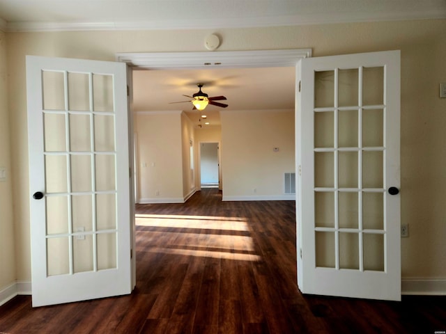 spare room with visible vents, wood-type flooring, baseboards, and ornamental molding