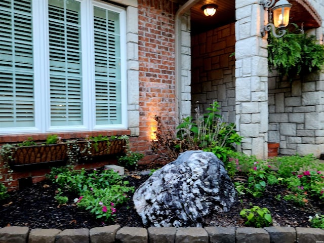 entrance to property featuring brick siding