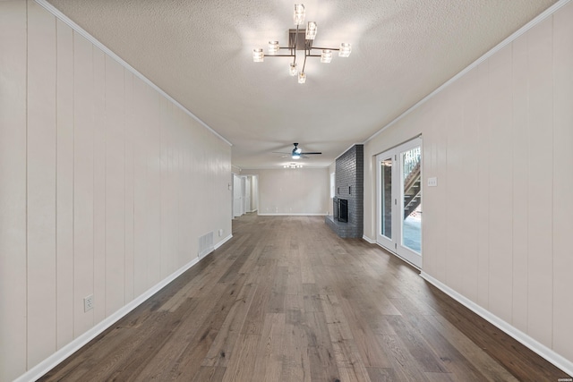 interior space with dark wood-style floors, visible vents, ornamental molding, and a textured ceiling