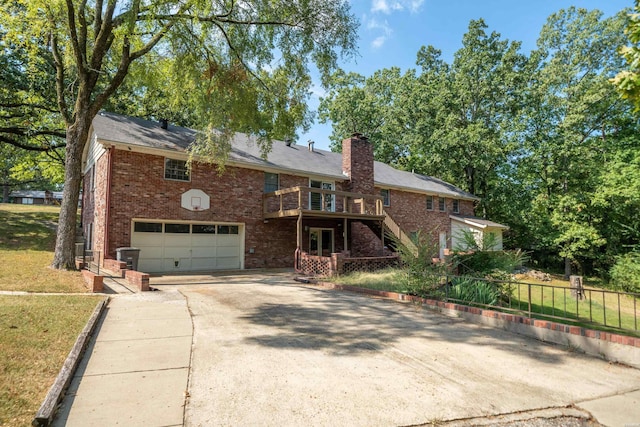 view of front of home with an attached garage, brick siding, concrete driveway, stairway, and a chimney