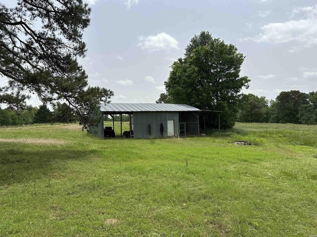 1966 Thomas Loop, Bismarck, AR 71929 - view of green lawn featuring an outbuilding and a pole building