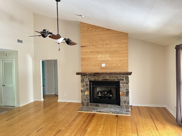 1966 Thomas Loop, Bismarck, AR 71929 - unfurnished living room featuring ceiling fan, wood finished floors, high vaulted ceiling, a fireplace, and baseboards