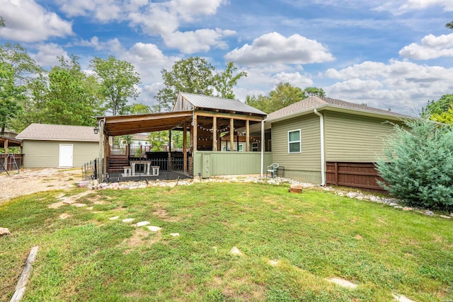 back of property featuring fence and a lawn