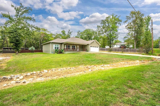 view of front of home with an attached garage, fence, and a front lawn