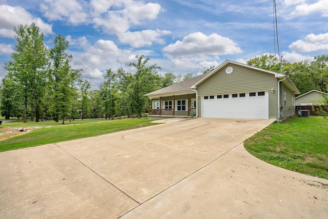 ranch-style home featuring a garage, driveway, a front lawn, and central AC unit