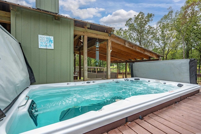 deck featuring hot tub deck surround