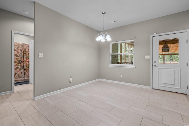 unfurnished dining area featuring baseboards, a healthy amount of sunlight, visible vents, and an inviting chandelier