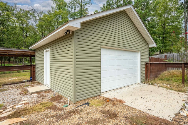 detached garage featuring fence