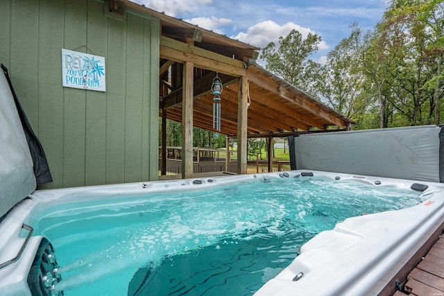 view of swimming pool with a covered hot tub