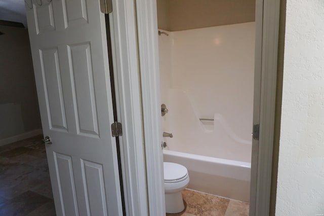 bathroom featuring toilet and shower / bathtub combination