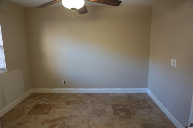 spare room featuring baseboards and ceiling fan