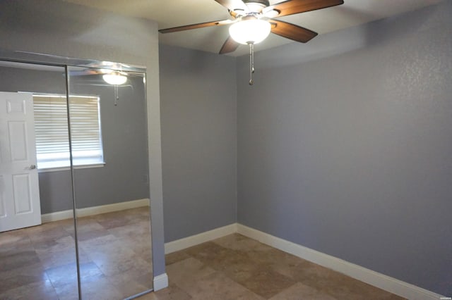 unfurnished bedroom featuring baseboards, a closet, and ceiling fan