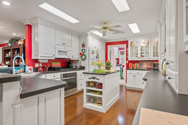 120 Southview Cir, Hot Springs, AR 71913 - kitchen featuring appliances with stainless steel finishes, dark countertops, white cabinetry, recessed lighting, and ornamental molding
