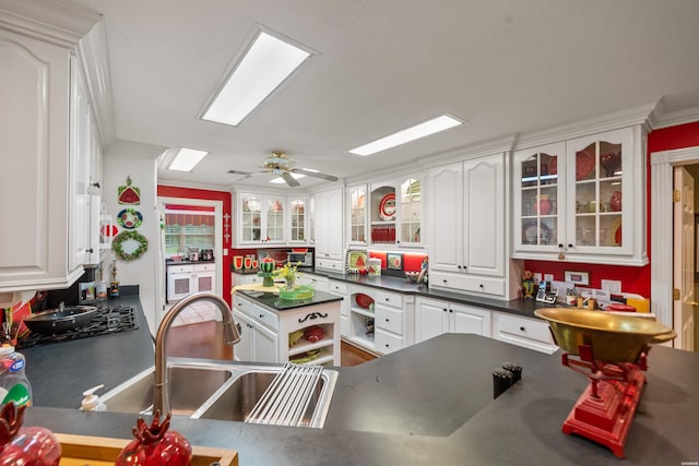 120 Southview Cir, Hot Springs, AR 71913 - kitchen with dark countertops, white cabinets, a ceiling fan, glass insert cabinets, and ornamental molding