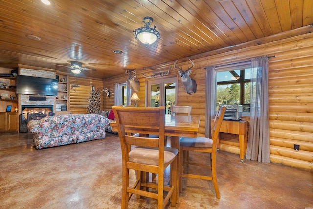 dining space featuring finished concrete flooring, a lit fireplace, log walls, and wood ceiling