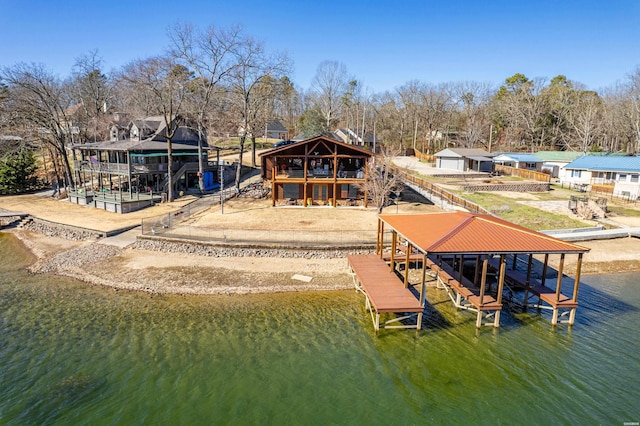 view of dock featuring a residential view, a water view, and boat lift