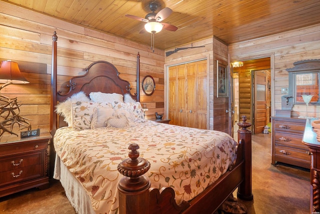 carpeted bedroom featuring wood walls, wood ceiling, ceiling fan, and a closet