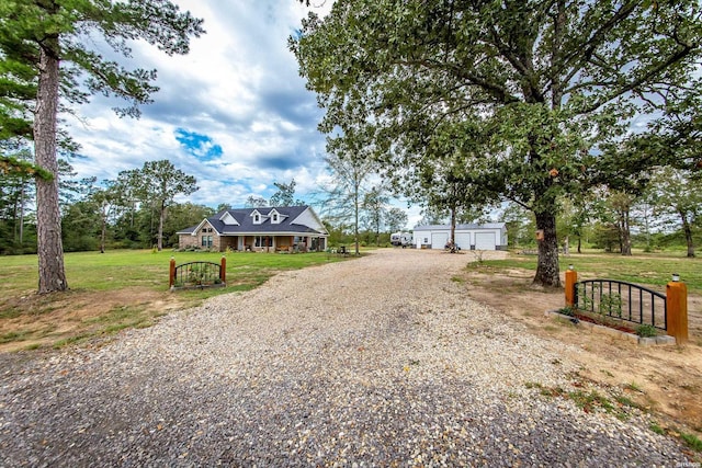 view of road with driveway and a gate