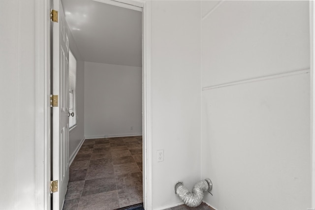 interior space featuring stone finish flooring and baseboards