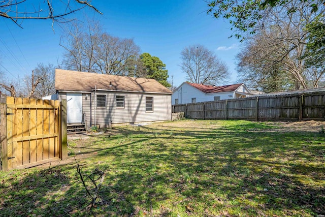 view of yard with a fenced backyard and entry steps