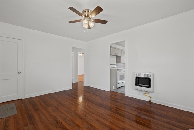 unfurnished living room featuring a ceiling fan, heating unit, wood finished floors, and baseboards