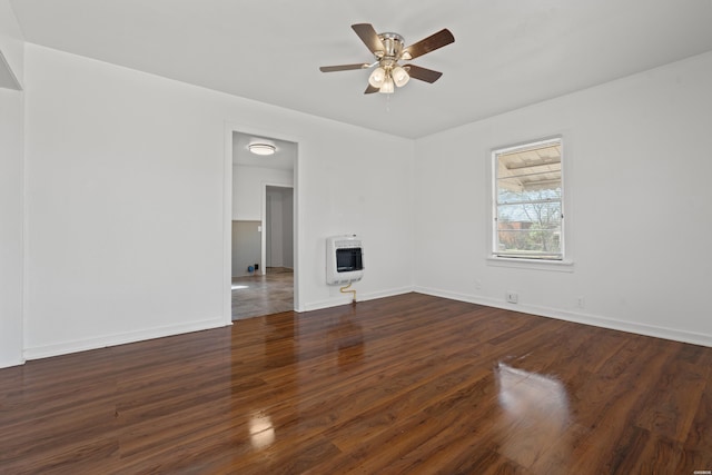 unfurnished living room with heating unit, baseboards, a ceiling fan, and wood finished floors