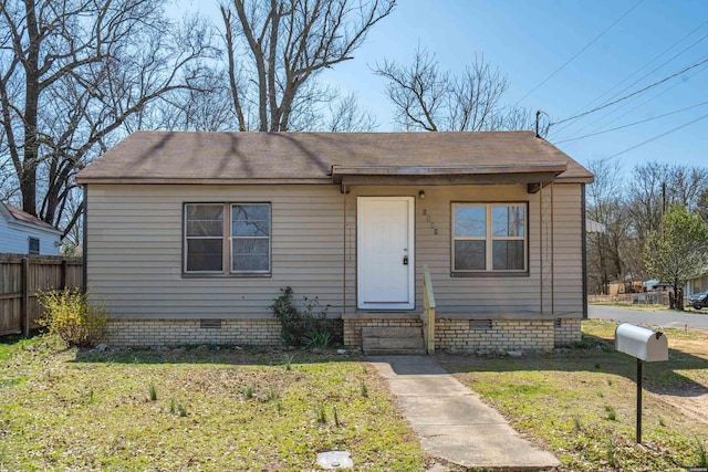 view of front of house featuring entry steps, a front lawn, fence, and crawl space