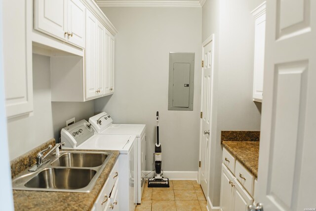 washroom featuring cabinet space, electric panel, separate washer and dryer, a sink, and light tile patterned flooring