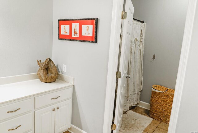 bathroom with tile patterned flooring and a shower with shower curtain