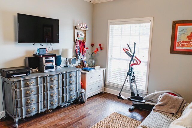 bedroom with dark wood-type flooring and baseboards